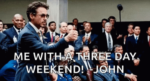 A Man In A Suit And Tie Is Giving A Thumbs Up To A Crowd Of People . GIF