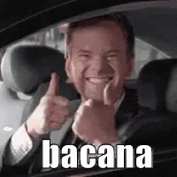 A Man In A Suit And Tie Is Giving A Thumbs Up While Sitting In A Car . GIF