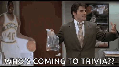 A Man In A Suit And Tie Is Holding A Bag Of Food In Front Of A Basketball Player . GIF