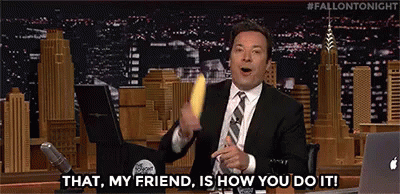 A Man In A Suit And Tie Is Holding A Banana And Saying `` That , My Friend , Is How You Do It ! `` GIF