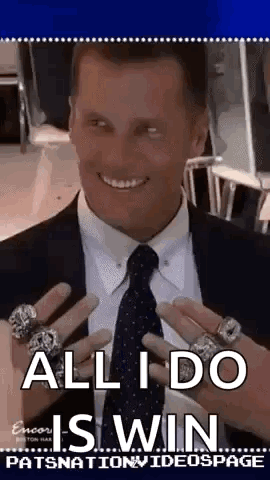 A Man In A Suit And Tie Is Holding A Bunch Of Rings On His Hands . GIF