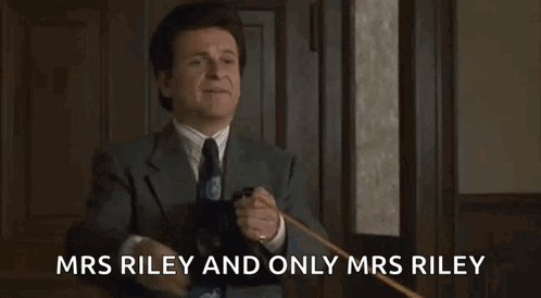 A Man In A Suit And Tie Is Holding A Cane And Giving A High Five . GIF