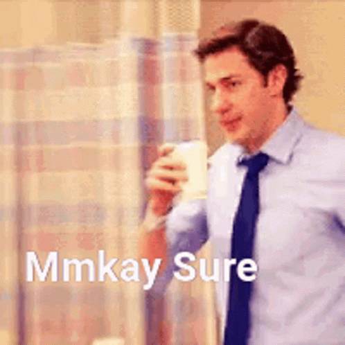 A Man In A Suit And Tie Is Holding A Cup Of Coffee And Says `` Mmkay Sure '' . GIF