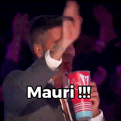 A Man In A Suit And Tie Is Holding A Cup That Says Mauri !!! GIF