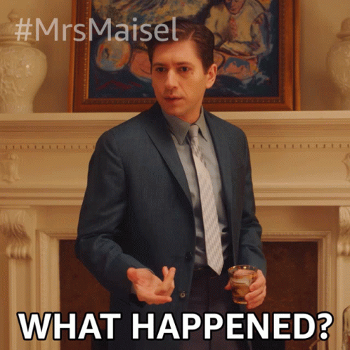 A Man In A Suit And Tie Is Holding A Glass And Says What Happened GIF