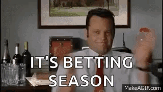 A Man In A Suit And Tie Is Holding A Glass Of Wine And Saying `` It 'S Betting Season '' GIF