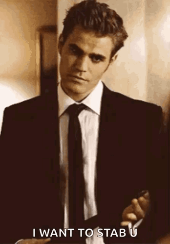 A Man In A Suit And Tie Is Holding A Gun And Saying `` I Want To Stab U '' . GIF