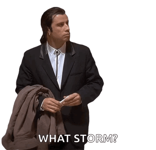 A Man In A Suit And Tie Is Holding A Jacket And Says What Storm GIF