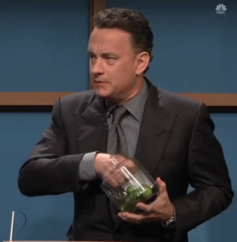 A Man In A Suit And Tie Is Holding A Jar Of Pickles With The Words I Wanted A Pickle Below Him GIF