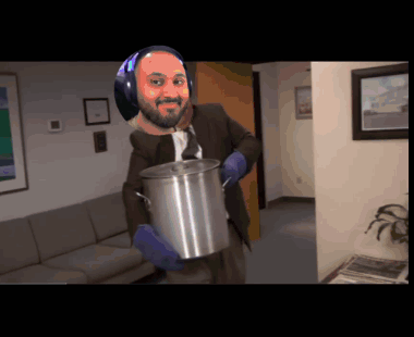 A Man In A Suit And Tie Is Holding A Large Pot GIF