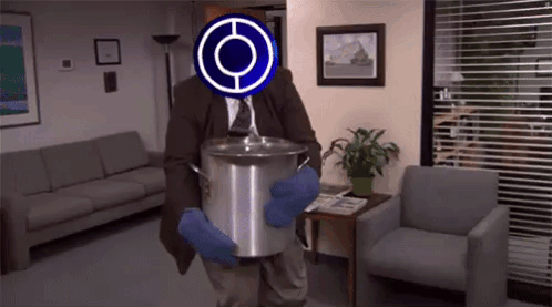 A Man In A Suit And Tie Is Holding A Large Pot In A Living Room . GIF