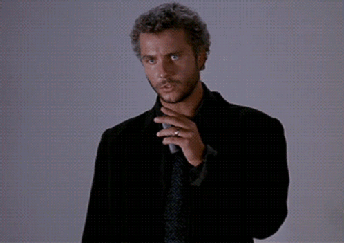 A Man In A Suit And Tie Is Holding A Microphone And Says " This Is My Design " GIF