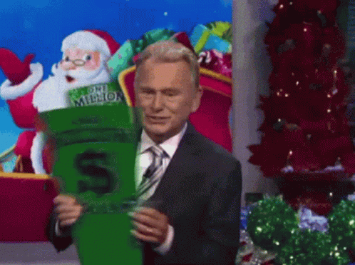 A Man In A Suit And Tie Is Holding A One Million Dollar Socks GIF