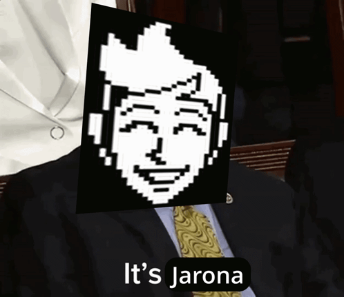 A Man In A Suit And Tie Is Holding A Picture Of A Pixelated Face With The Words It 'S Jarona Underneath It GIF