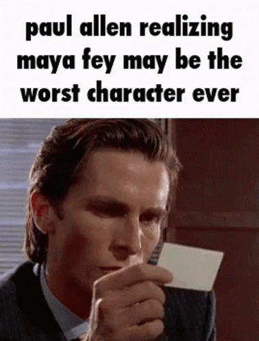 A Man In A Suit And Tie Is Holding A Piece Of Paper And Making A Funny Face . GIF