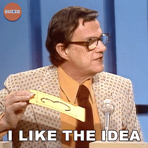 A Man In A Suit And Tie Is Holding A Piece Of Paper That Says " I Like The Idea " On It GIF