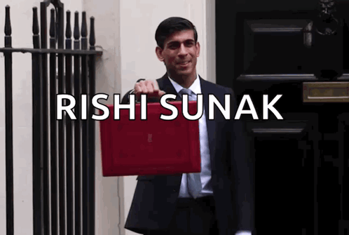 A Man In A Suit And Tie Is Holding A Red Briefcase With The Name Rishi Sunak Written Above Him GIF