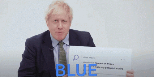 A Man In A Suit And Tie Is Holding A Sign That Says " Blue " GIF