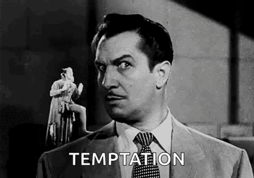 A Man In A Suit And Tie Is Holding A Statue Of A Woman In His Hand . GIF
