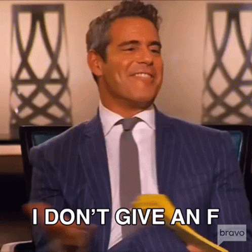 Man In Suit Holding Yellow Object Saying I Don T Give An F GIF