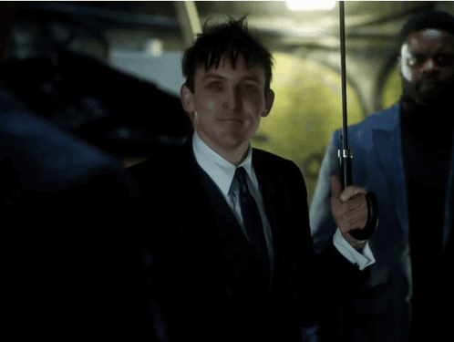 A Man In A Suit And Tie Is Holding An Umbrella And Says All In Fun GIF