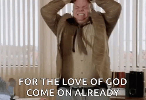 A Man In A Suit And Tie Is Holding His Head And Screaming In An Office . GIF