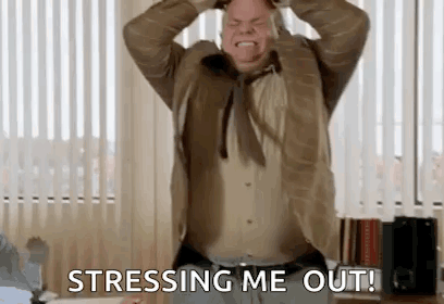 A Man In A Suit And Tie Is Holding His Head In His Hands And Saying `` Stressing Me Out '' . GIF