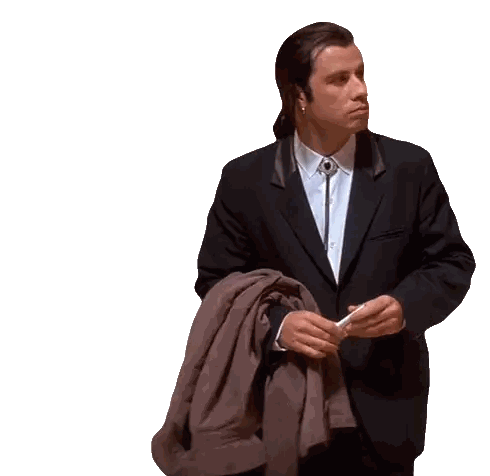 a man in a suit and tie is holding his jacket over his shoulder