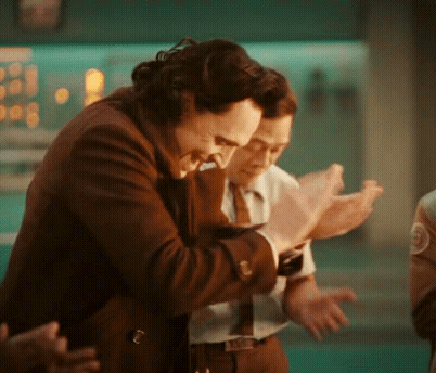 A Man In A Suit And Tie Is Hugging Another Man In A Suit And Tie . GIF