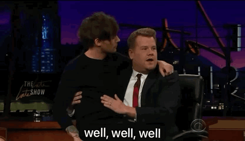 A Man In A Suit And Tie Is Hugging Another Man In A Suit And Tie . GIF
