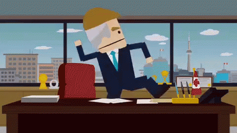 A Man In A Suit And Tie Is Jumping Over A Desk With A Canadian Flag On It GIF