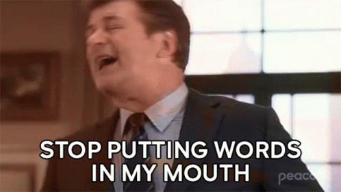 A Man In A Suit And Tie Is Laughing And Saying `` Stop Putting Words In My Mouth '' GIF