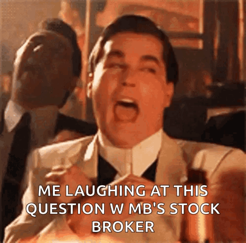 A Man In A Suit And Tie Is Laughing At A Question About A Stock Broker GIF