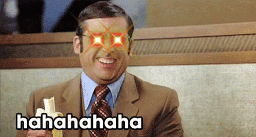 Man In Suit Laughing Holding Banana Hahaha Text GIF