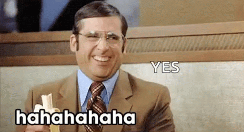 A Man In A Suit And Tie Is Laughing While Holding A Napkin And A Banana . GIF
