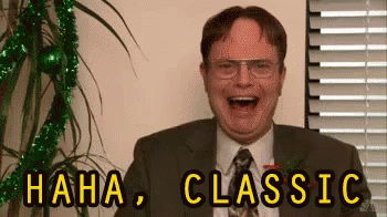 A Man In A Suit And Tie Is Laughing With The Words `` Haha , Classic '' Written Above Him . GIF