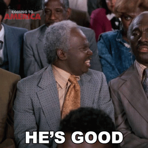 A Man In A Suit And Tie Is Laughing With The Words He 'S Good Below Him GIF