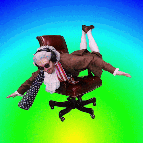 A Man In A Suit And Tie Is Laying On A Chair With His Feet Up GIF