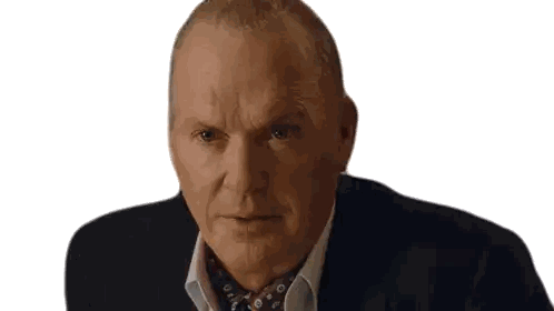 a man in a suit and tie is looking at the camera with a serious look on his face