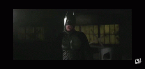 A Man In A Suit And Tie Is Looking At The Camera With The Letters Ch Below Him GIF
