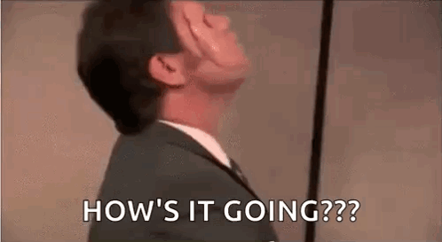A Man In A Suit And Tie Is Looking Up And Saying `` How 'S It Going '' . GIF