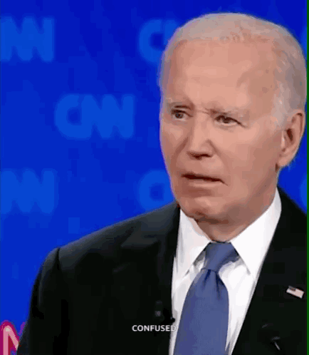 A Man In A Suit And Tie Is Making A Confused Face While Talking On Cnn GIF