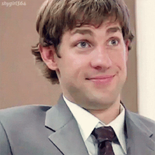 A Man In A Suit And Tie Is Making A Face GIF