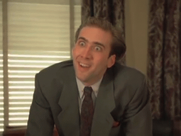 A Man In A Suit And Tie Is Making A Face GIF