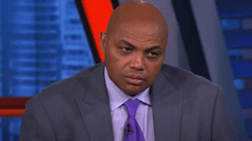 a man in a suit and tie is making a face
