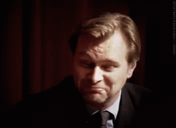 A Man In A Suit And Tie Is Making A Funny Face . GIF