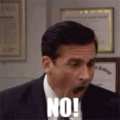 A Man In A Suit And Tie Is Making A Funny Face And Saying No ! GIF