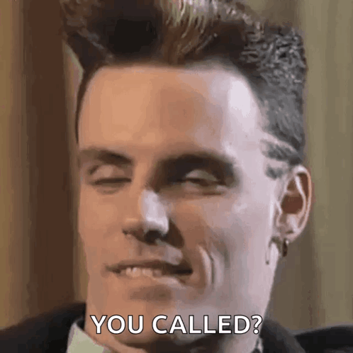 A Man In A Suit And Tie Is Making A Funny Face And Saying You Called . GIF