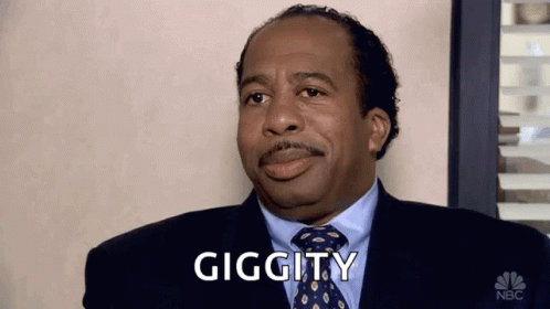 A Man In A Suit And Tie Is Making A Funny Face And Says Giggity . GIF