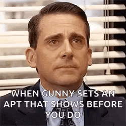 A Man In A Suit And Tie Is Making A Funny Face In Front Of A Window With Blinds . GIF
